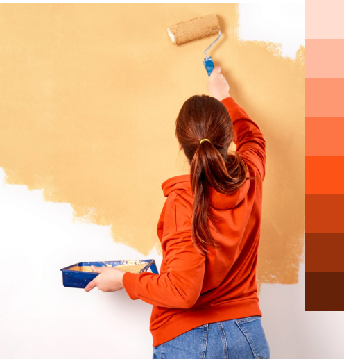 mulher pintando e uma escala de cores laranjas ao lado